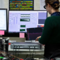 Engineer in lab using Moku:Pro device and interacting with Moku software UI