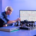 An engineer using FPGA-based instrumentation from Liquid Instruments to accelerate free-space optical communications